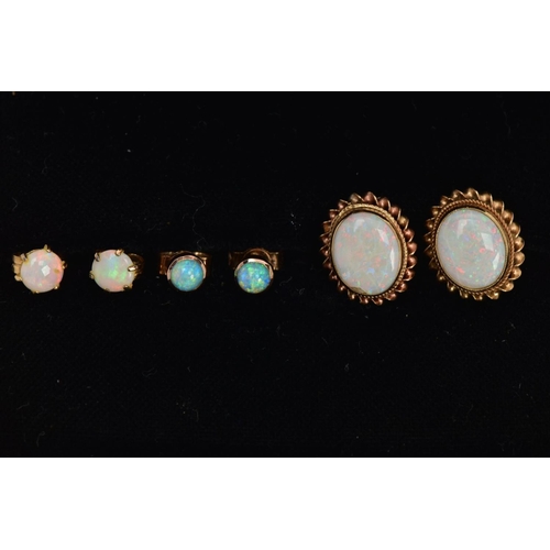 12 - THREE PAIRS OF OPAL EARRINGS, to include a pair of oval opal earrings bezel set within a rope twist ... 