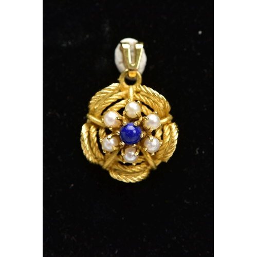 14 - A YELLOW METAL FLORAL GEM SET PENDANT, a lapis lazuli centre surrounded by six seed pearls prong set... 