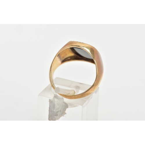 15 - A 9CT GOLD ONYX SIGNET RING, a rounded square cut onyx set with a milgrain edge, approximate width 1... 