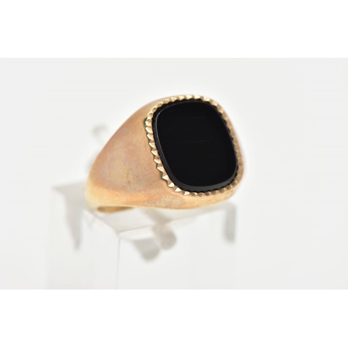 15 - A 9CT GOLD ONYX SIGNET RING, a rounded square cut onyx set with a milgrain edge, approximate width 1... 