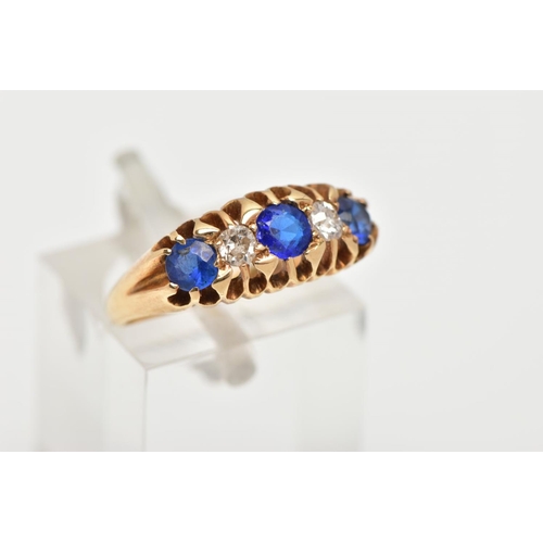 2 - AN EARLY 20TH CENTURY 18CT GOLD FIVE STONE RING, designed with a central blue stone assessed as a ga... 