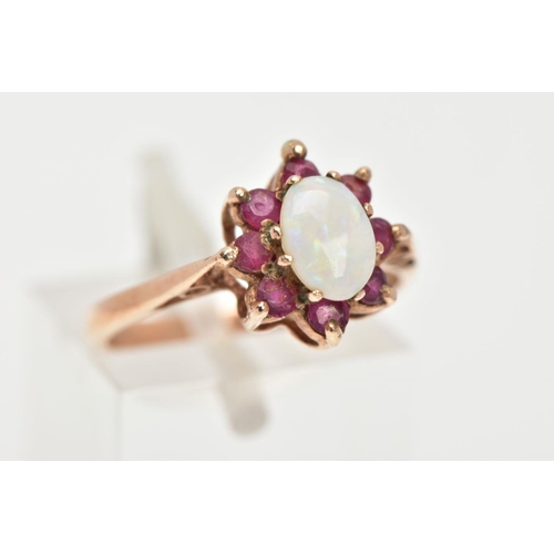 30 - A 9CT GOLD OPAL AND RUBY RING, centring on an oval cut opal, prong set within a surround of eight ci... 