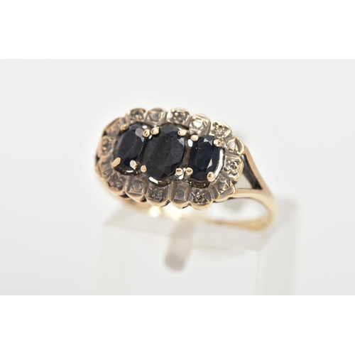 33 - A 9CT GOLD SAPPHIRE RING, three oval cut blue sapphires prong set in a surround of eight round brill... 