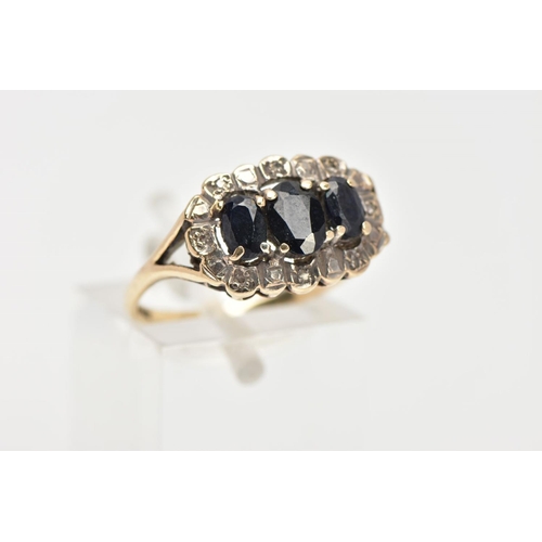 33 - A 9CT GOLD SAPPHIRE RING, three oval cut blue sapphires prong set in a surround of eight round brill... 