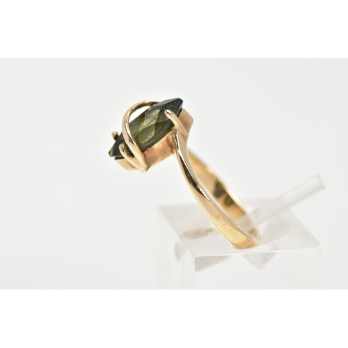 35 - A 9CT GOLD GEM SET RING, a green marquise cut stone assessed as tourmaline, prong set with a band of... 