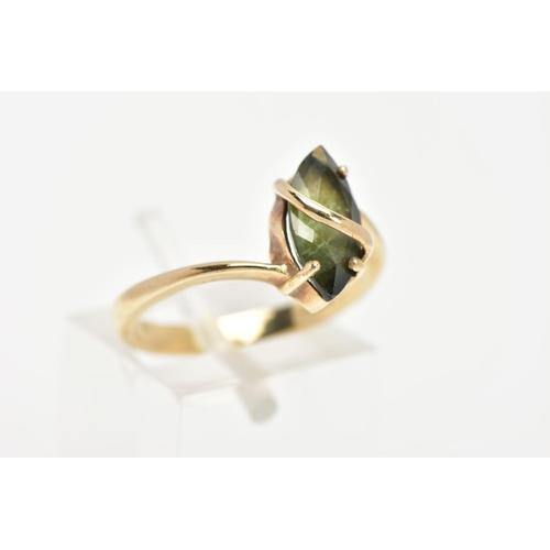 35 - A 9CT GOLD GEM SET RING, a green marquise cut stone assessed as tourmaline, prong set with a band of... 