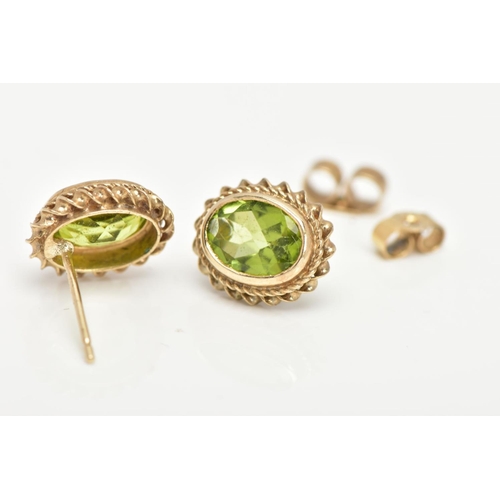 36 - A PAIR OF 9CT GOLD PERIDOT EARRINGS, oval cut peridot bezel set in yellow gold and a rope twist surr... 