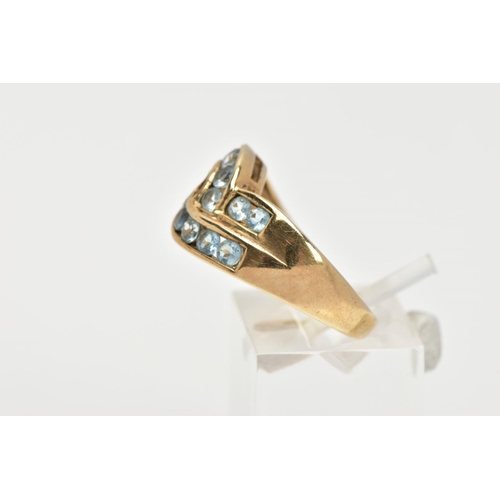 37 - AN AQUAMARINE DRESS RING, sixteen circular cut aquamarine stones channel set in a double row cross o... 