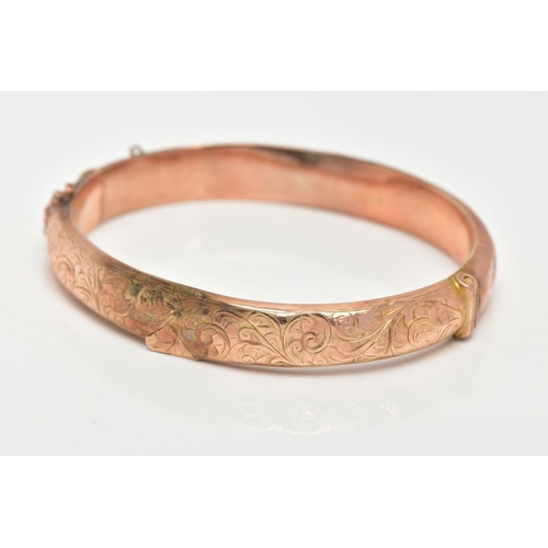 44 - A 9CT GOLD BANGLE, an AF hinged hollow domed bangle with scrolling foliage detail, approximate width... 