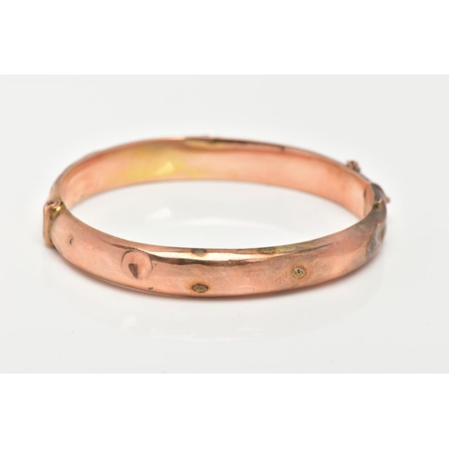 44 - A 9CT GOLD BANGLE, an AF hinged hollow domed bangle with scrolling foliage detail, approximate width... 