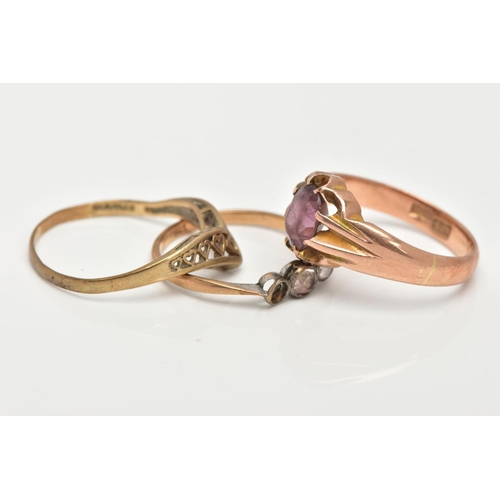 45 - A 9CT GOLD RING AND TWO YELLOW METAL RINGS, a yellow gold wishbone ring featuring an open work desig... 