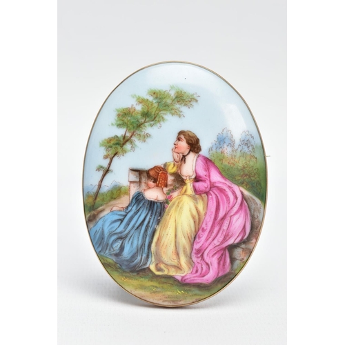 63 - A LARGE PAINTED CERAMIC BROOCH, painted scene depicting two lady's in dresses sitting on a wall with... 