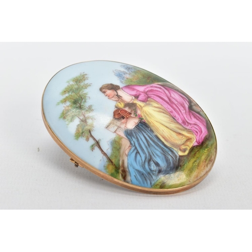 63 - A LARGE PAINTED CERAMIC BROOCH, painted scene depicting two lady's in dresses sitting on a wall with... 