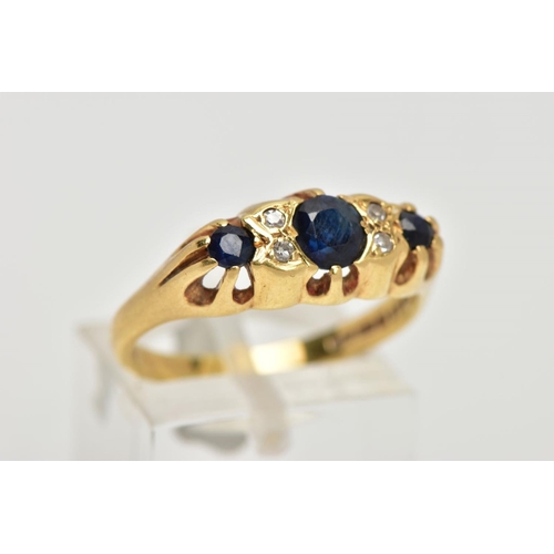 68 - AN 18CT GOLD SAPPHIRE AND DIAMOND RING, designed with three graduated blue sapphires, interspaced wi... 