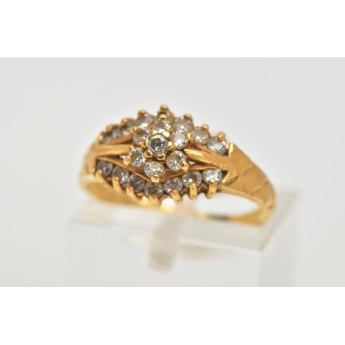 69 - A 22CT GOLD CUBIC ZIRCONIA DRESS RING, set with a flower cluster of colourless cubic zirconia betwee... 