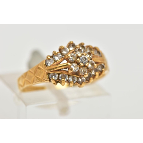 69 - A 22CT GOLD CUBIC ZIRCONIA DRESS RING, set with a flower cluster of colourless cubic zirconia betwee... 