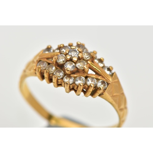 69 - A 22CT GOLD CUBIC ZIRCONIA DRESS RING, set with a flower cluster of colourless cubic zirconia betwee... 