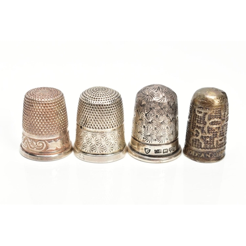 72 - FOUR THIMBLES, to include a 'Charles Horner' thimble hallmarked Chester 1906, 4.8 grams, one stamped... 