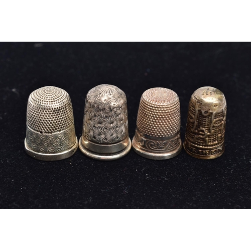 72 - FOUR THIMBLES, to include a 'Charles Horner' thimble hallmarked Chester 1906, 4.8 grams, one stamped... 