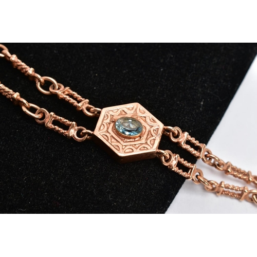 78 - A 9CT ROSE GOLD ALBERTINA, textured hexagonal centre set with an oval cut blue topaz collet mounted,... 