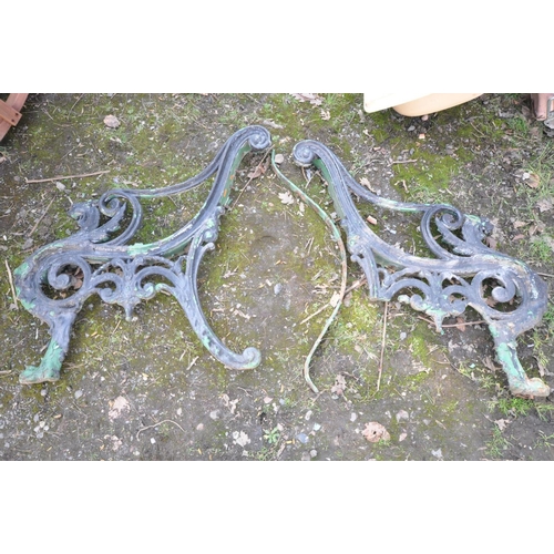 1106 - A PAIR OF HEAVY CAST IRON BENCH ENDS (condition:-one missing one back leg to one end)