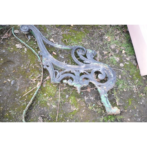 1106 - A PAIR OF HEAVY CAST IRON BENCH ENDS (condition:-one missing one back leg to one end)