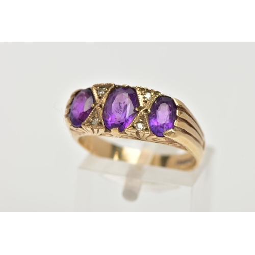 107 - A MODERN 9CT GOLD SEVEN STONE DRESS RING, designed with three oval cut amethyst's, interspaced with ... 