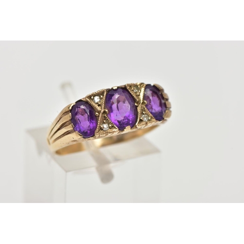 107 - A MODERN 9CT GOLD SEVEN STONE DRESS RING, designed with three oval cut amethyst's, interspaced with ... 