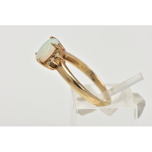 108 - A 9CT GOLD OPAL AND DIAMOND RING, centring on a four claw set oval white opal cabochon, showing flas... 