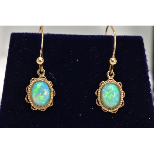 109 - A PAIR OF OPAL CABOCHON DROP EARRINGS, yellow metal drop earrings each of an oval form, oval white o... 