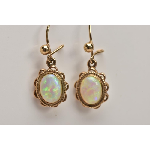 109 - A PAIR OF OPAL CABOCHON DROP EARRINGS, yellow metal drop earrings each of an oval form, oval white o... 