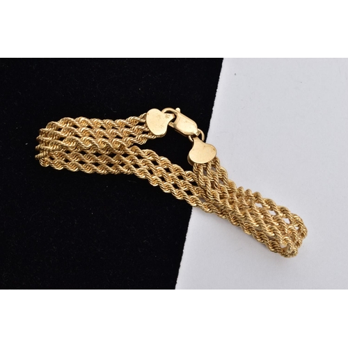 122 - A 9CT GOLD BRACELET, designed as a triple row of rope twist chains, fitted with a lobster claw clasp... 