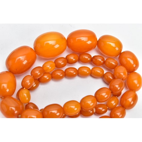 164 - A GRADUATED AMBER COLOUR BAKELITE BEAD NECKLACE, oval graduated beads, largest measuring approximate... 