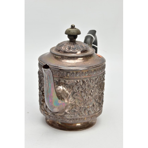 184 - A LATE VICTORIAN SILVER TEAPOT, embossed floral and foliate design, fitted with an ebonised wooden h... 