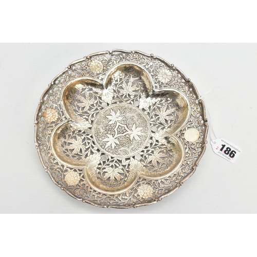 186 - AN INDIAN PIERCED WHITE METAL BONBON DISH, of a circular form, wavy detailed rim, pierced foliate de... 