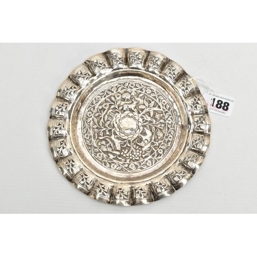 188 - AN INDIAN WHITE METAL TRAY, of a circular form, decorated to the centre with an embossed forest scen... 