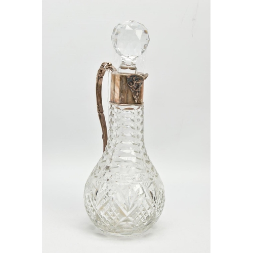 190 - A SILVER MOUNTED GLASS CLARET JUG, Bacchus face to the collar, fitted with a scrolling handle decora... 