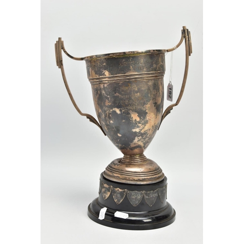 192 - AN AF SILVER TROPHY CUP, misshapen tropy cup of a tapered form, fiited with two handles, on a round ... 