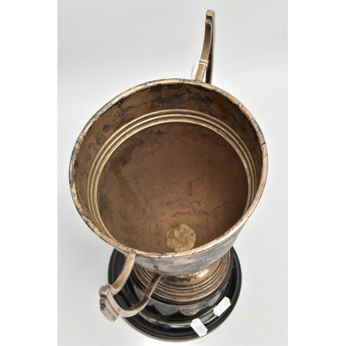 192 - AN AF SILVER TROPHY CUP, misshapen tropy cup of a tapered form, fiited with two handles, on a round ... 