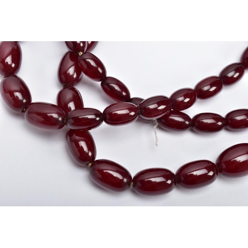 29 - A CHERRY AMBER BAKELITE NECKLACE,  graduating oval beads, largest measuring approximately 11mm x 7mm... 