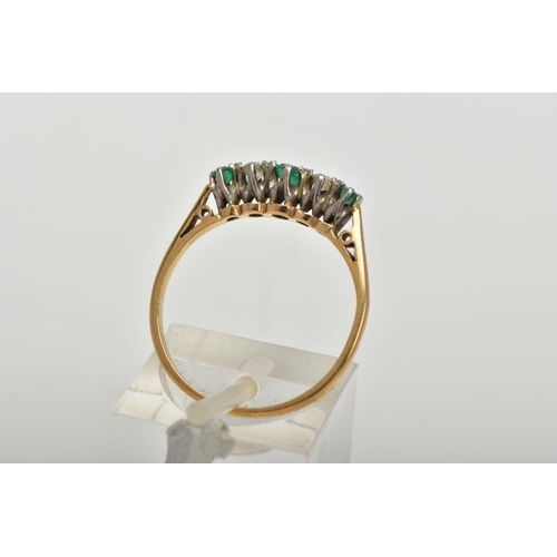 32 - AN EMERALD AND DIAMOND FIVE STONE RING, an emerald cut emerald set centrally with two round brillian... 