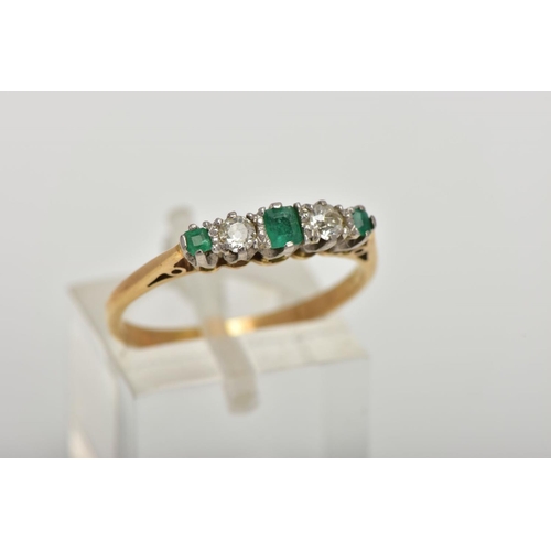 32 - AN EMERALD AND DIAMOND FIVE STONE RING, an emerald cut emerald set centrally with two round brillian... 
