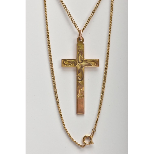 33 - A YELLOW METAL CROSS PENDANT,  a large cross detailing a scrolling foliage pattern, approximate dime... 