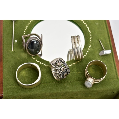 40 - AN ASSORTMENT OF SILVER AND WHITE METAL RINGS,  to include a large oval cabochon tigers eye set in a... 