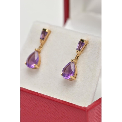 42 - A PAIR OF YELLOW METAL AMETHYST DROP EARRINGS, each designed with a claw set, pear cut amethyst drop... 