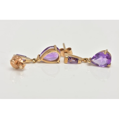 42 - A PAIR OF YELLOW METAL AMETHYST DROP EARRINGS, each designed with a claw set, pear cut amethyst drop... 