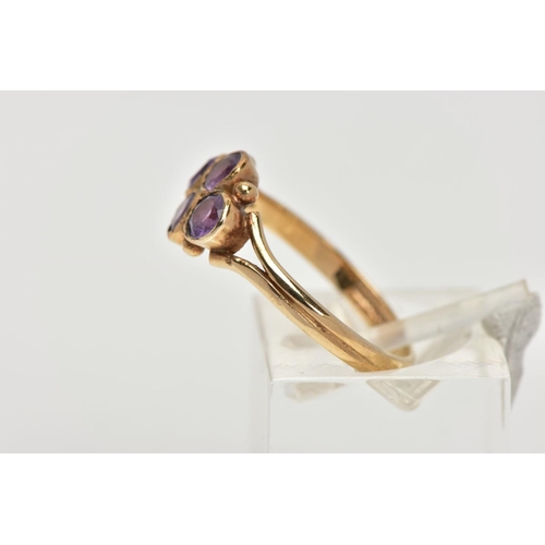 45 - A 9CT GOLD AMETHYST RING, designed with four circular cut amethysts each bezel set into a lozenge sh... 