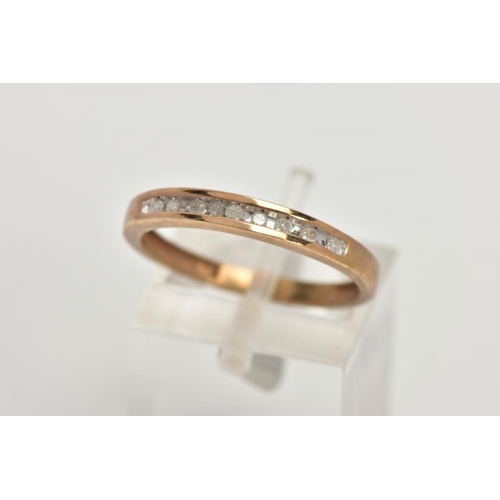 68 - A 9CT GOLD DIAMOND HALF ETERNITY RING, designed with a row of channel set single cut diamonds, stamp... 