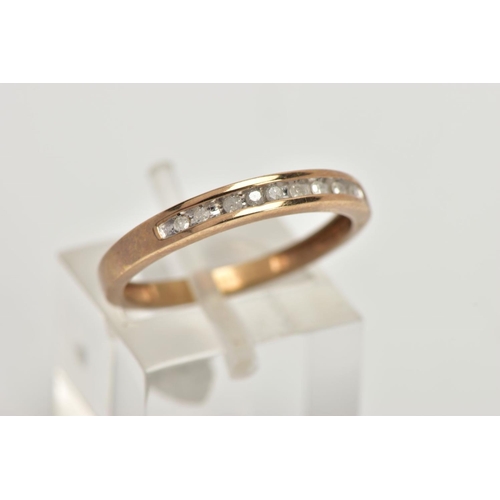 68 - A 9CT GOLD DIAMOND HALF ETERNITY RING, designed with a row of channel set single cut diamonds, stamp... 