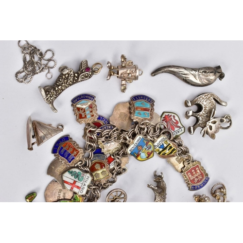 81 - TWO CHARM BRACELETS AND LOOSE CHARMS, the first a silver double curb link bracelet, fitted with nine... 